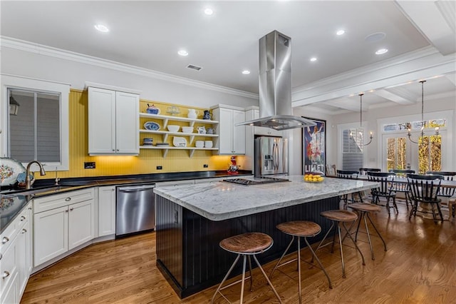 kitchen with a breakfast bar area, a kitchen island, island exhaust hood, dark stone countertops, and stainless steel appliances