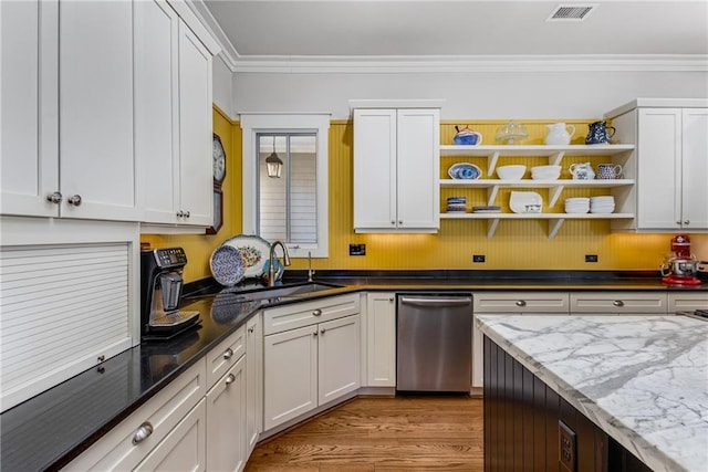 kitchen featuring stainless steel dishwasher, open shelves, visible vents, white cabinets, and a sink