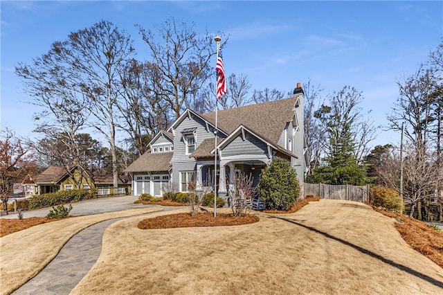 craftsman-style house featuring a garage, aphalt driveway, fence, a chimney, and a shingled roof