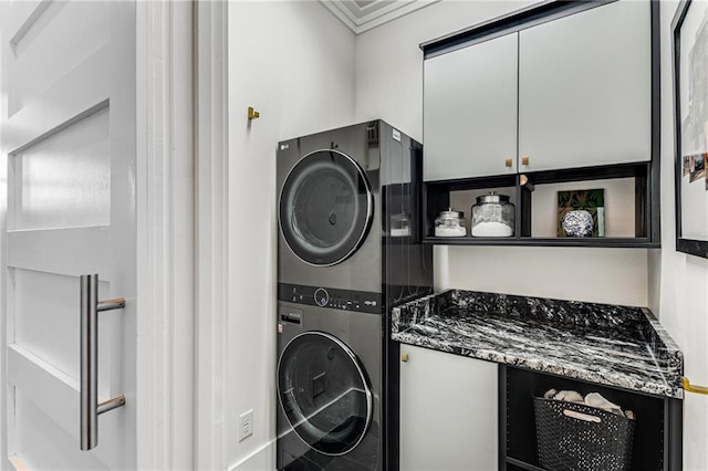 clothes washing area featuring stacked washer / drying machine
