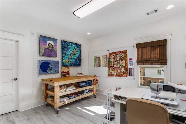office featuring recessed lighting, baseboards, visible vents, and light wood-style floors