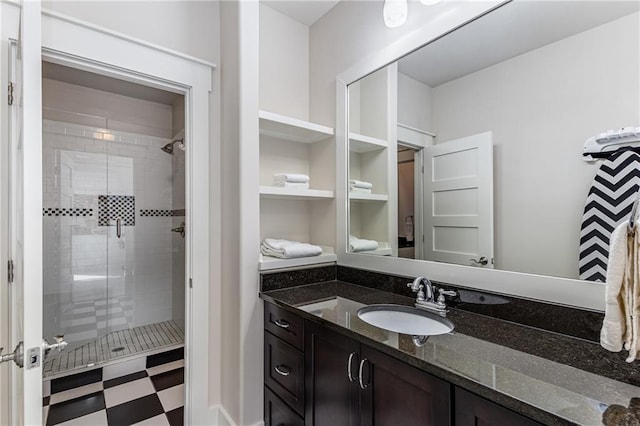 full bathroom with vanity, a shower stall, and tile patterned floors