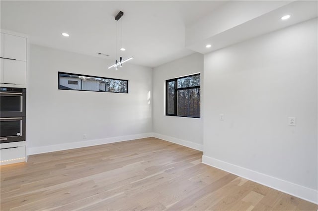 unfurnished dining area with light hardwood / wood-style flooring