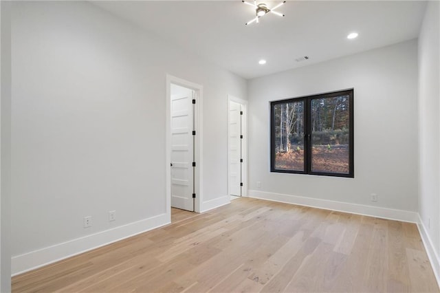 unfurnished room with light hardwood / wood-style floors