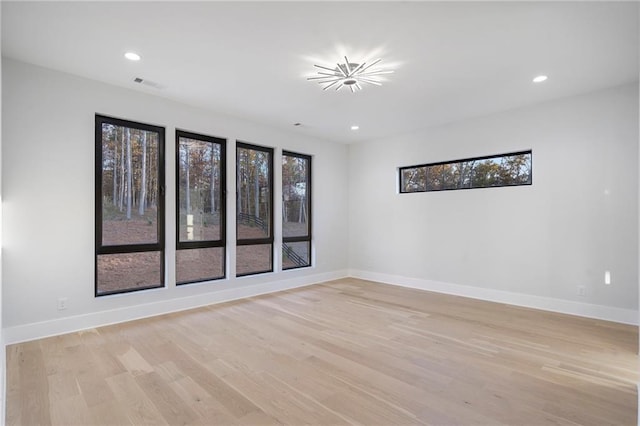 unfurnished room with light hardwood / wood-style floors