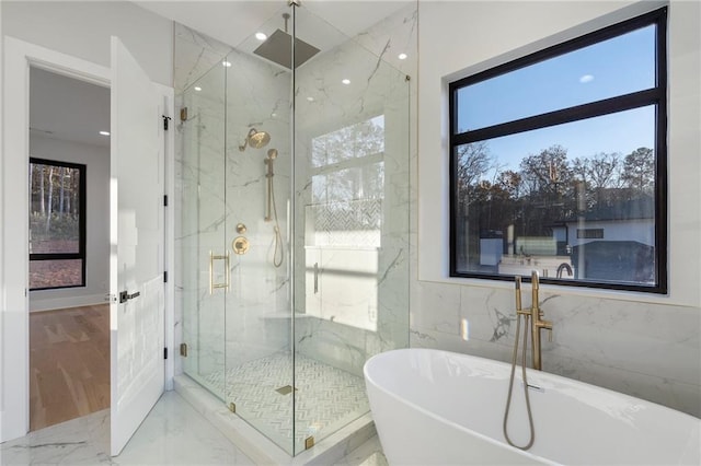 bathroom with independent shower and bath and tile walls