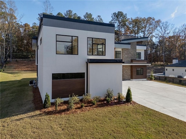 contemporary house with a garage and a front yard