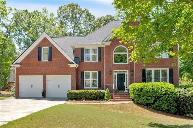 3921 Upland Way, Marietta, GA 30066 - colonial-style house featuring driveway, brick siding, a front yard, and a garage
