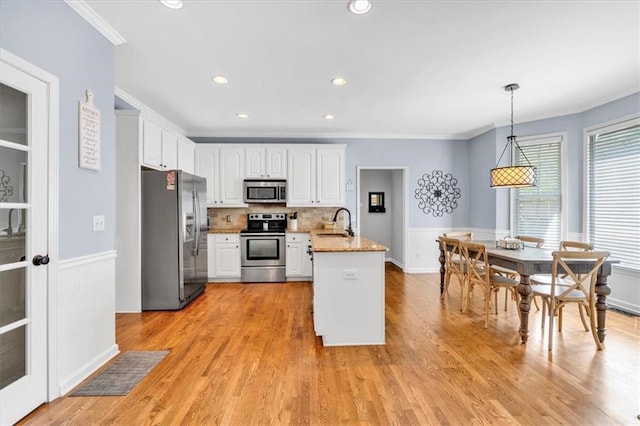 3921 Upland Way, Marietta, GA 30066 - kitchen with white cabinets, a peninsula, appliances with stainless steel finishes, and crown molding