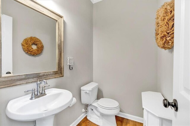 3921 Upland Way, Marietta, GA 30066 - bathroom featuring wood finished floors, baseboards, a sink, and toilet
