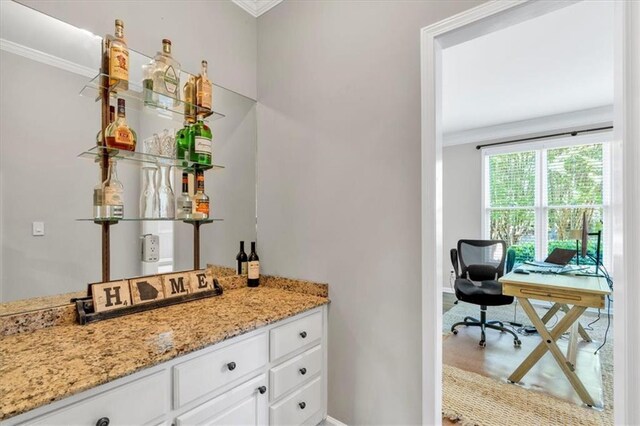 3921 Upland Way, Marietta, GA 30066 - bar with baseboards, crown molding, and a dry bar