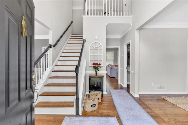 3921 Upland Way, Marietta, GA 30066 - stairway with wood finished floors, a towering ceiling, baseboards, ornamental molding, and visible vents
