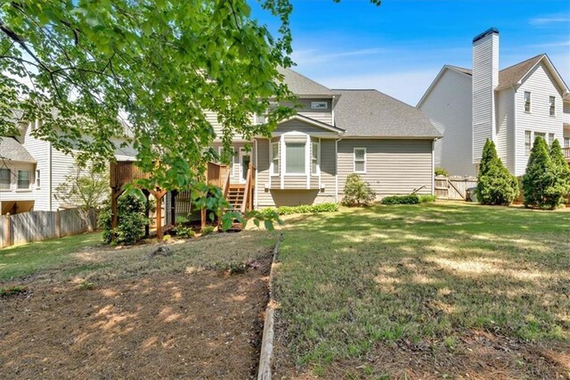 3921 Upland Way, Marietta, GA 30066 - back of house featuring fence, roof with shingles, a yard, and stairway
