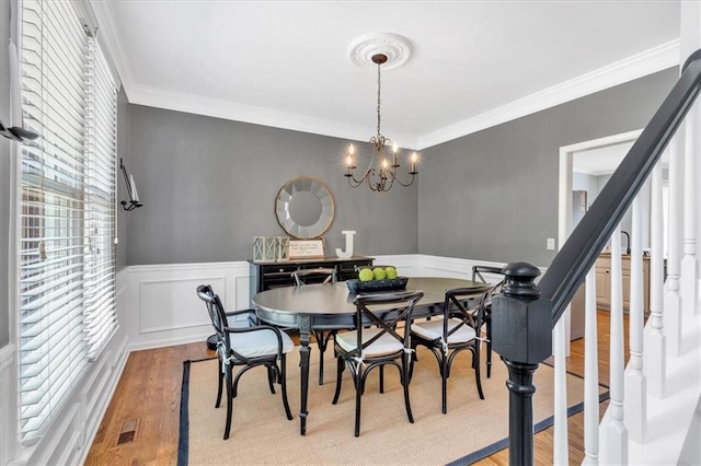 3921 Upland Way, Marietta, GA 30066 - dining area with wood finished floors, crown molding, stairs, and wainscoting