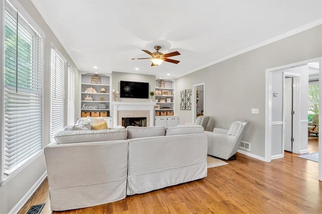 3921 Upland Way, Marietta, GA 30066 - living area with wood finished floors, crown molding, baseboards, a fireplace, and ceiling fan