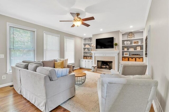 3921 Upland Way, Marietta, GA 30066 - living area with wood finished floors, ornamental molding, baseboards, a fireplace, and ceiling fan