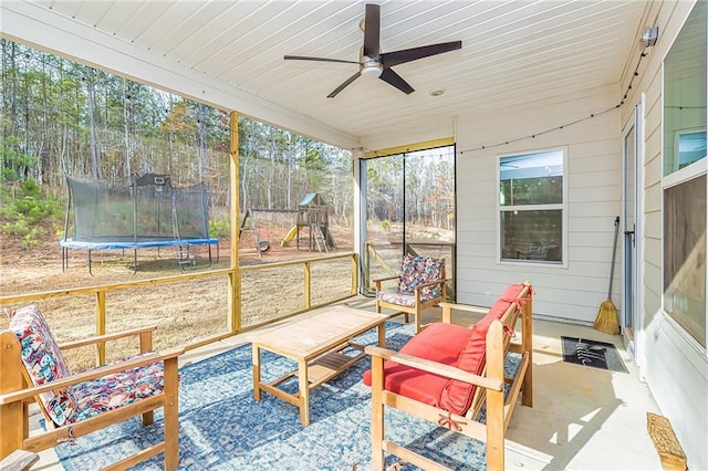 sunroom / solarium with ceiling fan and wooden ceiling