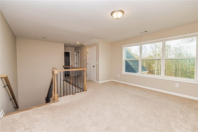 unfurnished room featuring light carpet