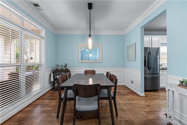 859 Scales Rd, Suwanee, GA 30024 - dining space featuring wood finished floors, crown molding, and wainscoting