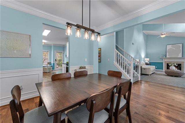 859 Scales Rd, Suwanee, GA 30024 - dining space featuring stairway, crown molding, wood finished floors, ceiling fan, and wainscoting
