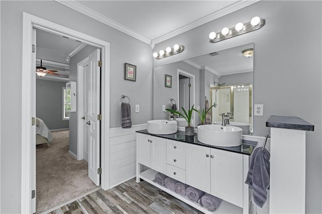 859 Scales Rd, Suwanee, GA 30024 - ensuite bathroom with crown molding, double vanity, wood finished floors, a ceiling fan, and a shower with door