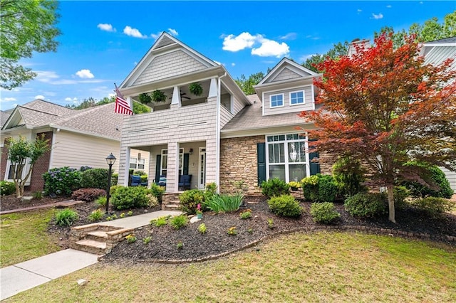 859 Scales Rd, Suwanee, GA 30024 - view of front of house featuring a balcony, a porch, a front yard, and stone siding
