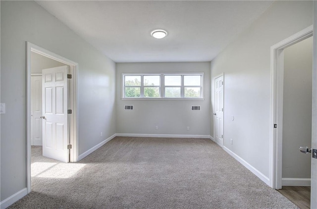 carpeted spare room with baseboards