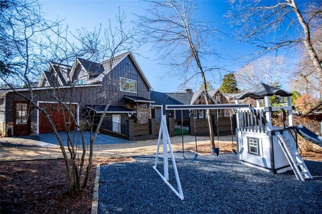202 Hickory Chase, Carrollton, GA 30117 - back of house featuring board and batten siding, a playground, and fence
