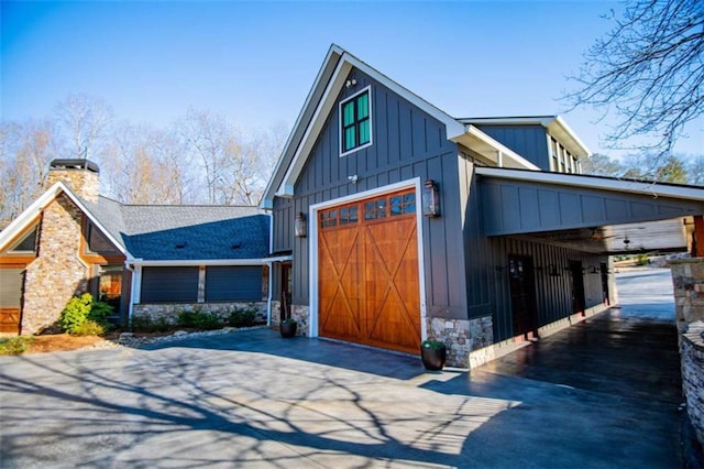 202 Hickory Chase, Carrollton, GA 30117 - view of side of home with board and batten siding, driveway, stone siding, and a chimney