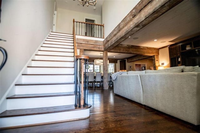202 Hickory Chase, Carrollton, GA 30117 - stairs featuring wood finished floors, a chandelier, beam ceiling, and recessed lighting