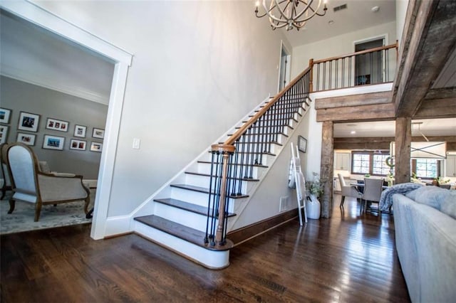 202 Hickory Chase, Carrollton, GA 30117 - staircase featuring wood finished floors, a chandelier, baseboards, and a towering ceiling
