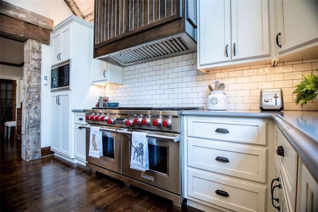 202 Hickory Chase, Carrollton, GA 30117 - kitchen featuring range with two ovens, custom exhaust hood, built in microwave, dark wood finished floors, and tasteful backsplash