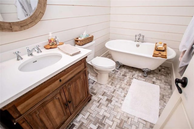 202 Hickory Chase, Carrollton, GA 30117 - bathroom with a freestanding bath, vanity, toilet, and wooden walls