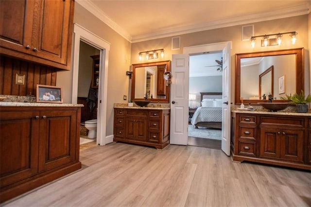 202 Hickory Chase, Carrollton, GA 30117 - bathroom with crown molding, wood finished floors, two vanities, toilet, and ensuite bath
