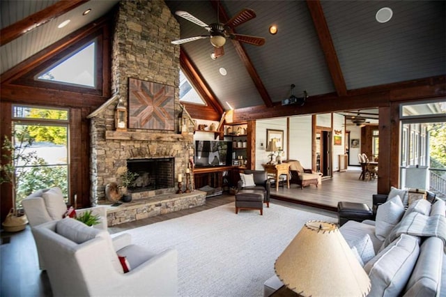 202 Hickory Chase, Carrollton, GA 30117 - living room featuring high vaulted ceiling, ceiling fan, a stone fireplace, beamed ceiling, and wood finished floors