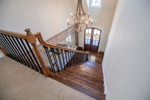 202 Hickory Chase, Carrollton, GA 30117 - stairs with a chandelier, a towering ceiling, french doors, wood finished floors, and baseboards
