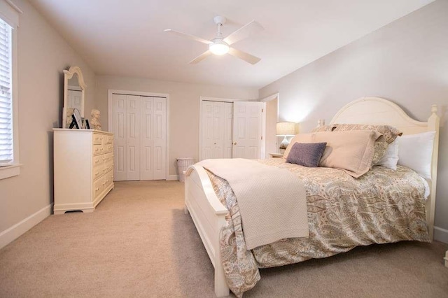 202 Hickory Chase, Carrollton, GA 30117 - bedroom with multiple closets, baseboards, light carpet, and a ceiling fan
