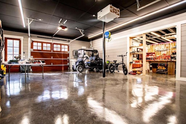 202 Hickory Chase, Carrollton, GA 30117 - garage featuring wood walls, a garage door opener, and a workshop area