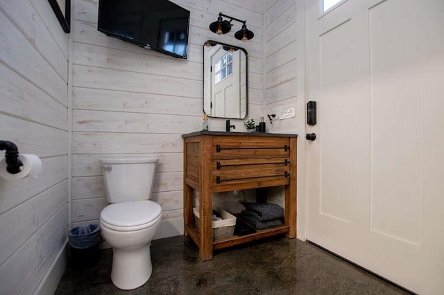 202 Hickory Chase, Carrollton, GA 30117 - half bath with toilet, wood walls, vanity, and finished concrete floors