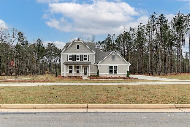 view of front of house featuring a porch and a front yard