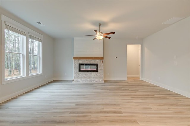 unfurnished living room with light wood-type flooring and ceiling fan