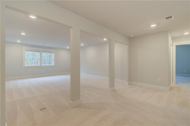 basement featuring light colored carpet