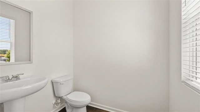 613 Lobelia Way, Locust Grove, GA 30248 - bathroom with a sink, toilet, and baseboards