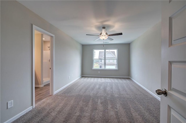 empty room featuring light colored carpet and ceiling fan