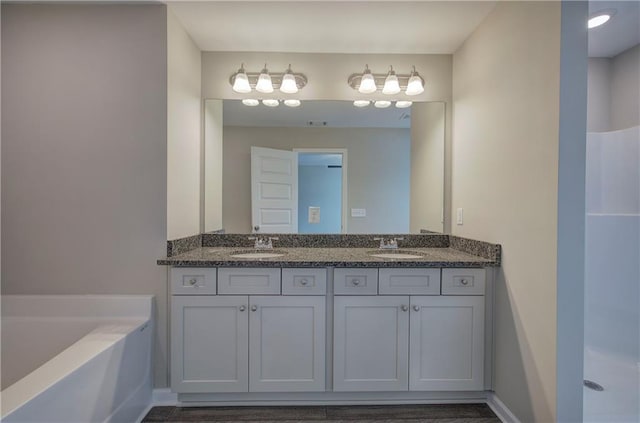 bathroom featuring vanity and a tub