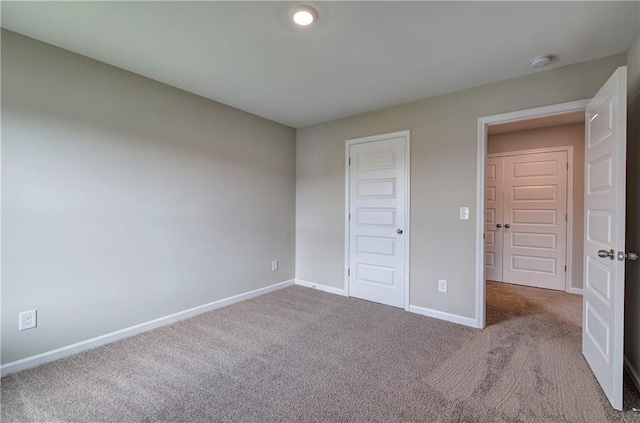 unfurnished bedroom with light colored carpet