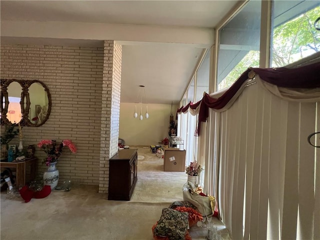 foyer featuring brick wall