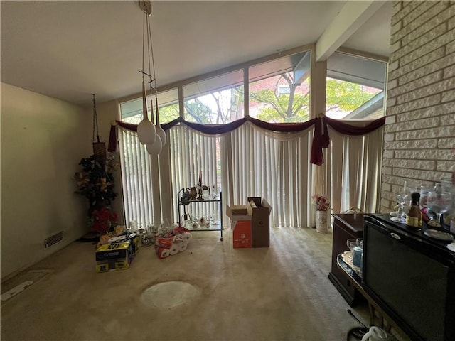 interior space featuring visible vents and beamed ceiling