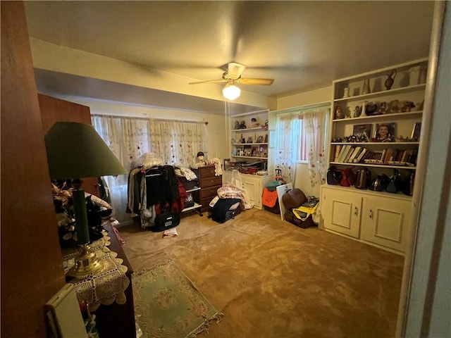 interior space featuring a ceiling fan and carpet floors