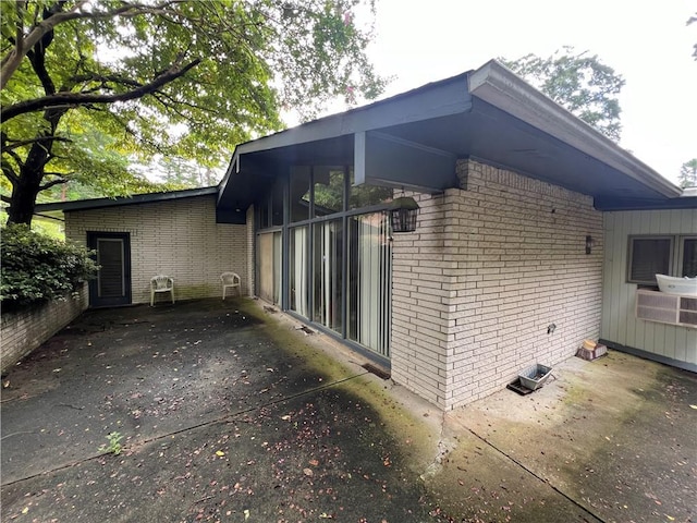 view of home's exterior with brick siding